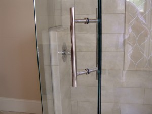 Custom door pull for frameless shower enclosures